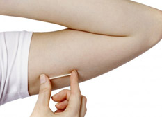 Nexplanon birth control implant against womans inner arm